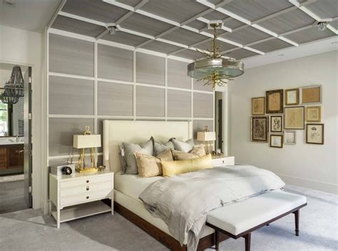 A Bedroom With A Bed Dressers And Pictures Hanging On The Wall Above It