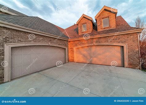 Beautiful Exterior Of Brick House With Dormers Above The Attached