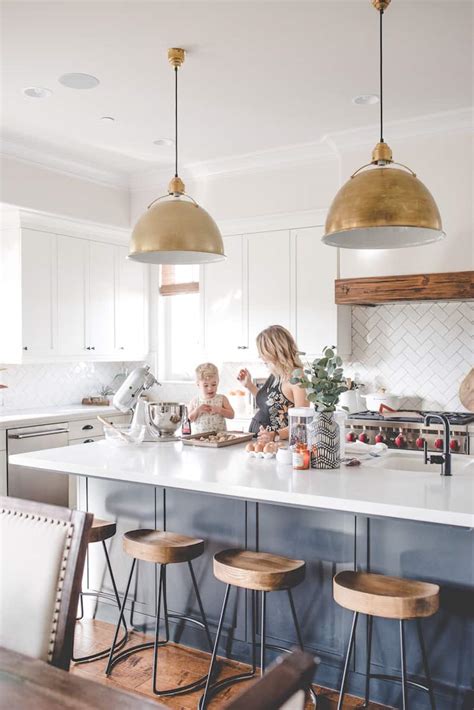 Chandelier lighting also hangs from the ceiling but features a branched system with many lights as opposed to one light like pendants. How to Choose Kitchen Island Lighting | Caroline on Design