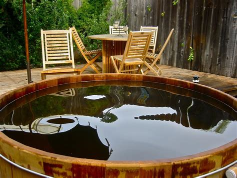 A hot tub is a large tub full of water used for hydrotherapy, relaxation or pleasure. Redwood hot tub in Santa Barbara backyard. http://www ...