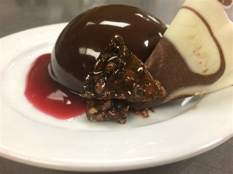 Spoon the mousse into the chocolate mould. Chocolate mousse dome with chocolate nib brittle and ...