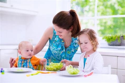 The best food delivery apps, including the cheapest food delivery apps to order from and food apps with the lowest delivery cost according to star ratings and online reviews. Mother And Children Cooking In A White Kitchen Stock Image ...