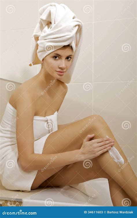 woman applying moisturizer cream on the legs stock image image of applying bodycare 34611603