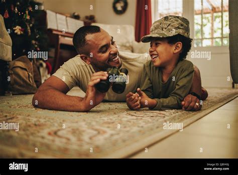 Father and son bonding at Christmas. Happy military dad spending the