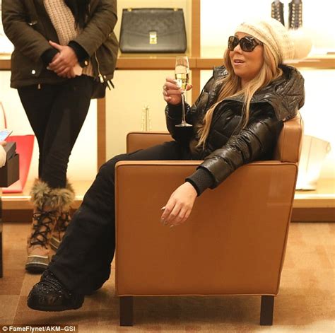 Mariah Carey Enjoys Some Champagne As She Shops While On Holiday In