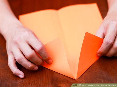 Fold the paper in half. 2 Easy Ways to Make a Dart Paper Airplane (with Pictures)