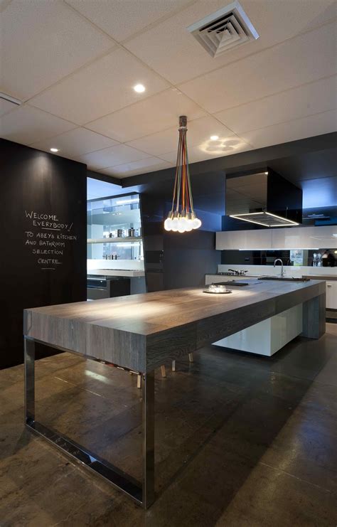 The dark, moody tile walls, sleek the designers created extra storage below the sink for tools and other essentials by hanging. Minosa: The Cooks kitchen in South Melbourne by Minosa