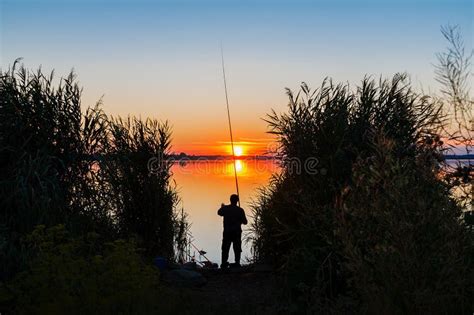 Sunset Over The Lake And Fisherman Stock Photo Image Of Person