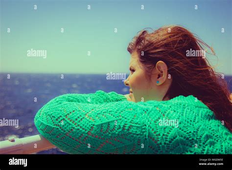Woman Leans On The Railing And Looking Out To Sea On The Horizon Stock