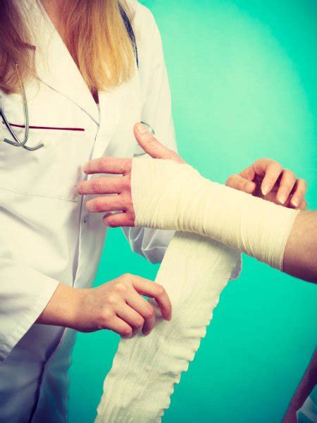Doctor Bandaging Sprained Wrist — Stock Photo © Anetlanda 135258880