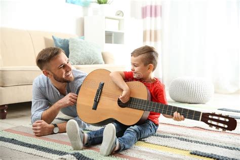 Father Teaching His Little Son To Play Guitar Stock Image Image Of