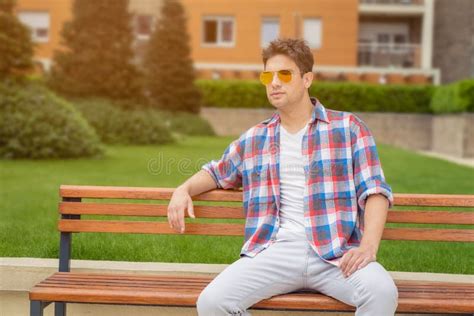 Young Guy Sitting On Bench Outdoors Fashion And Urban People Co Stock