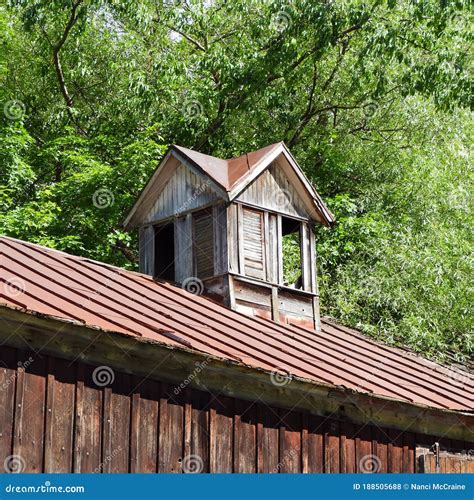 Vintage Shuttered Barn Cupola Sits On Rustic Tin Roof Stock Photo