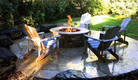 97 holman day rd, vassalboro, me 04989, us. Adirondack chairs sit around a firepit on a flagstone ...
