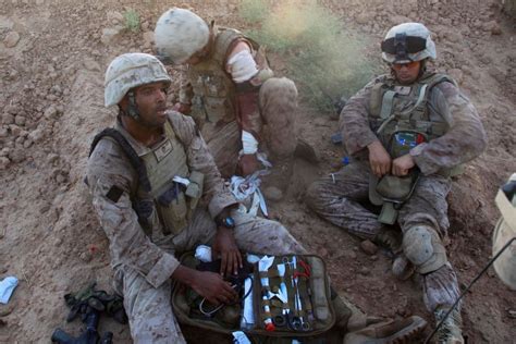 Navy Corpsmen Treating A Wounded Us Marine In Afghanistan December