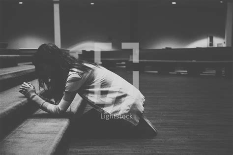 A Woman Kneeling In Prayer At An Altar — Photo — Lightstock