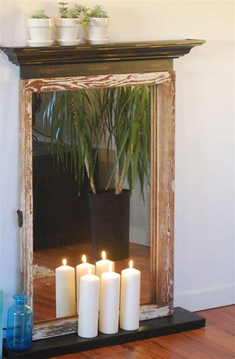 A fake fire creates a visual effect of flickering flames and fire colors. Easy DIY Faux Fireplace • The Budget Decorator