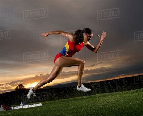 Female Athlete Leaving Starting Blocks Stock Photo Dissolve