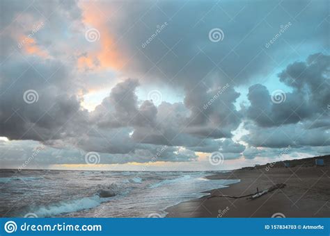 Seashore Sky Orange And Blue Tones Clouds And Sea Waves Sand Beach With