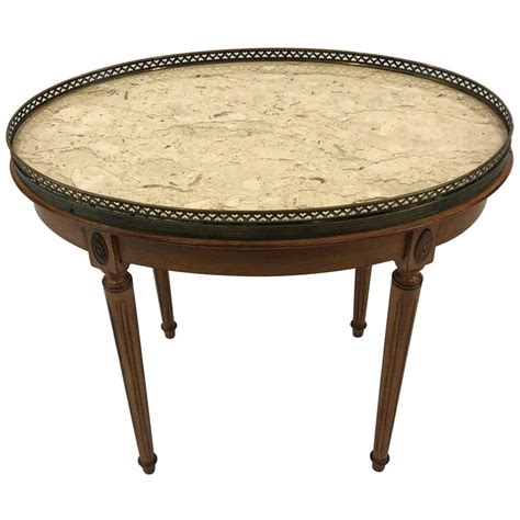 classic vintage fruitwood oval coffee table with marble top and brass gallery at 1stdibs