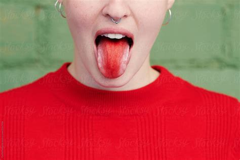 Playful Girl Showing Tongue With Red Tongue By Stocksy Contributor Guille Faingold Stocksy