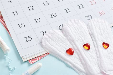 Calendar Of The Female Menstrual Cycle With Pads And Tampons On A Light Blue Background Stock