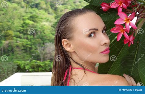 Young Woman Wearing Bikini With Wet Hair And Tree Flower On A Sunny Day Royalty Free Stock Image