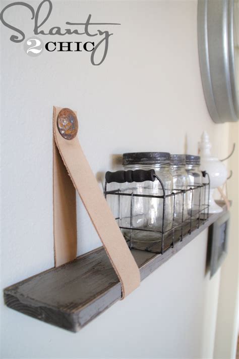 Make a pallet wall shelf for storing or arranging your items effortlessly. DIY $5 Shelves with Leather Straps - Shanty 2 Chic