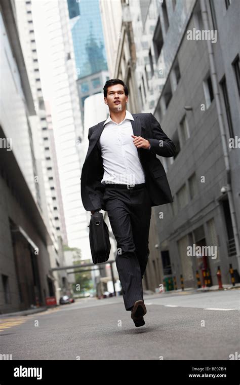 Businessman Running Down Street Stock Photo Alamy