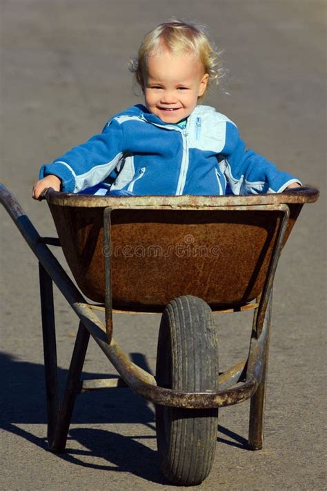 Smiling Child In Wheelbarrow Stock Photo Image Of Cheerful Young