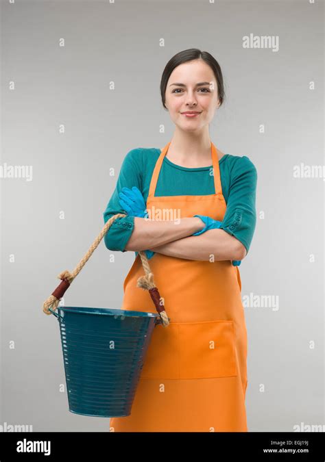 Happy Confident Cleaning Lady Holding Bucket With Arms Crossed On Grey
