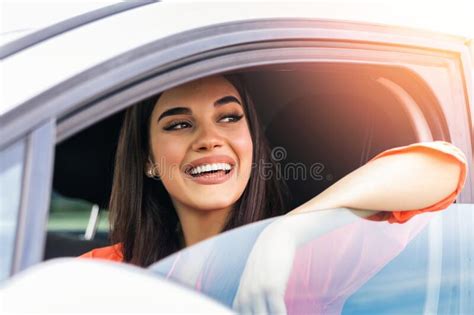 Young Woman Sitting In A Car Happy Woman Driving A Car And Smiling