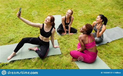 Group Of Beautiful Sporty Girls Taking Selfie Before Their Yoga Practice In Nature Stock Image