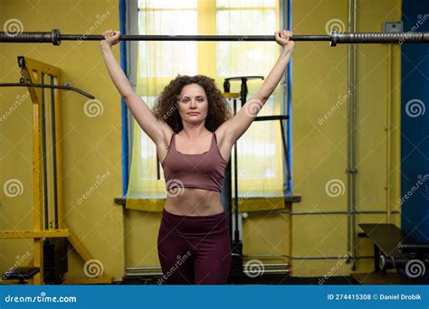 Strong Slim Girl At Gym Lifts Barbell Over Head Stock Photo Image Of