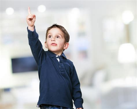 Adorable Child Pointing Upwards Photo Free Download