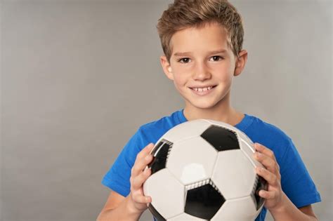 Premium Photo Cheerful Male Child Holding Classic Soccer Ball