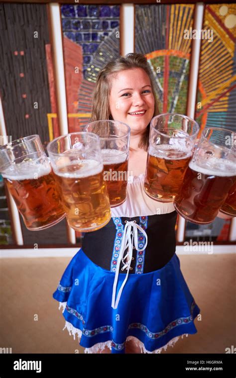 Waitress Holding Six Beer Steins During An Oktoberfest Event Stock