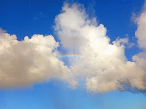 Rainbow Detail Between White Clouds And Tropical Blue Sky Spectacular