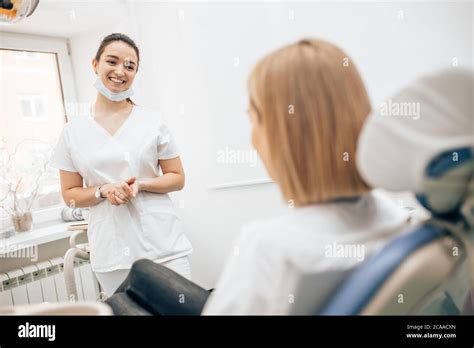Friendly Dentist Woman Treating Beautiful Patient In Dental Office