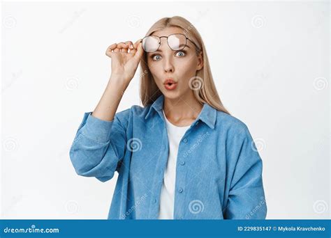 Portrait Of Blond Woman Taking Off Her Glasses Widen Eyes And Staring Impressed At Camera