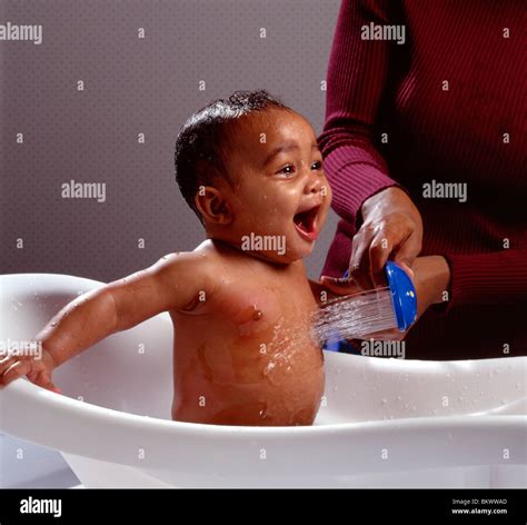 Happy African American Baby Boy Splashing In The Bath Tub Water Stock