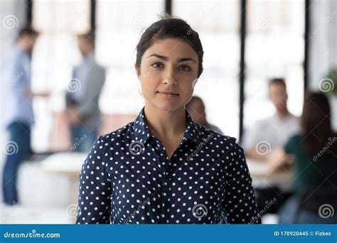 Portrait Of Confident Indian Businesswoman Posing In Office Stock Image