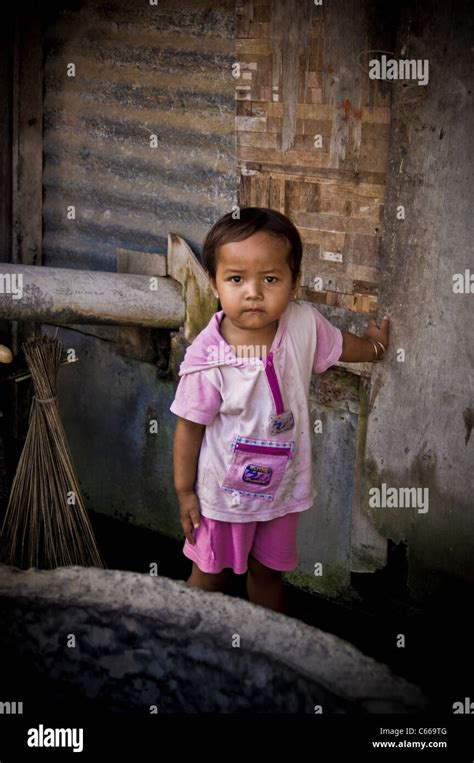 Young Balinese Girl Standing By The Water Well In Slum Area Of Bali