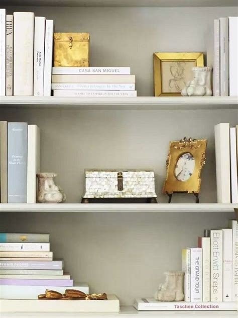 Large wooden shelving unit with multiple size shelves, cabinets and drawers dimensions: White and gold bookshelf styling | Bookcase decor ...