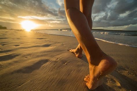 Barefoot On Beach Walking Towards Sunlight Waxmd