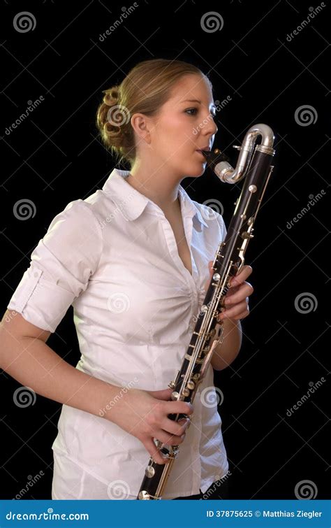 Pretty Young Woman Playing Bass Clarinet Royalty Free Stock Photo
