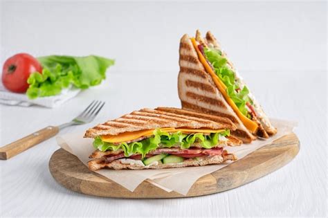 Premium Photo Two Homemade Sandwiches Of Ham Cheese Lettuce And Toasted Bread With Knife On