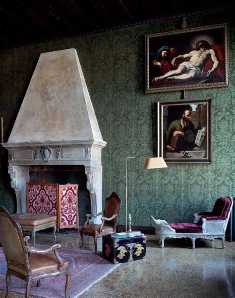 A Living Room With Green Walls And Paintings On The Wall Including An