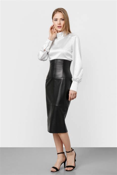 blonde modeling high waisted black leather midi skirt white silk blouse and ankle strap heels