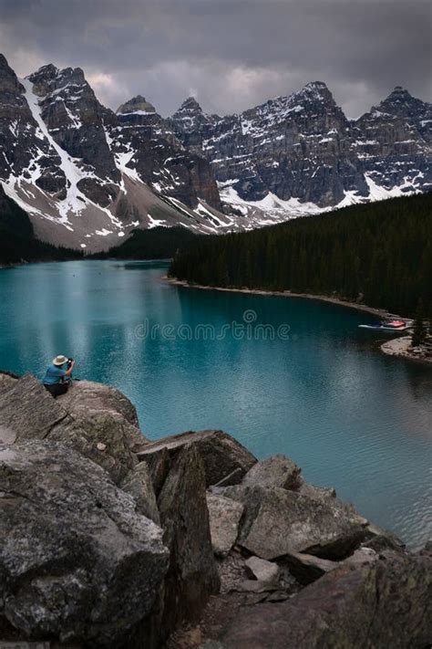 Photographer Taking Pictures Of Moraine Lake In Banff National Park